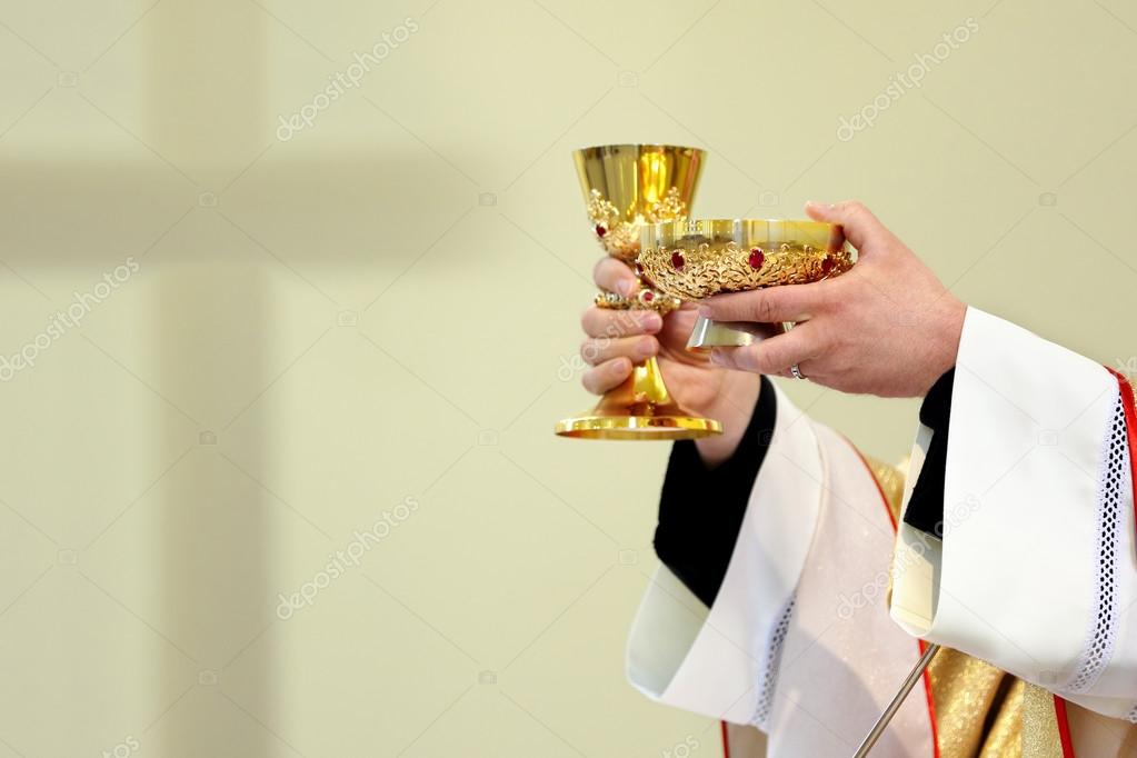 Priest celebrate a mass and holy communion at the church Stock Photo by