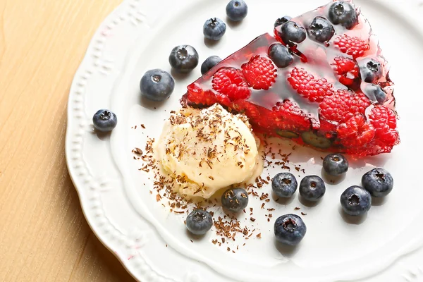Jelly dessert with raspberries, blueberries and ice cream — Stock Photo, Image