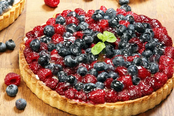 Fruit tart dessert with raspberries blackberries and cranberries