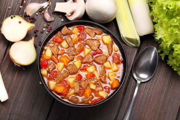 Beef stew soup on a wooden background — Stock Photo, Image