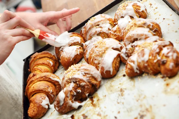 Fresh croissants iced with delicious cream — Stock Photo, Image