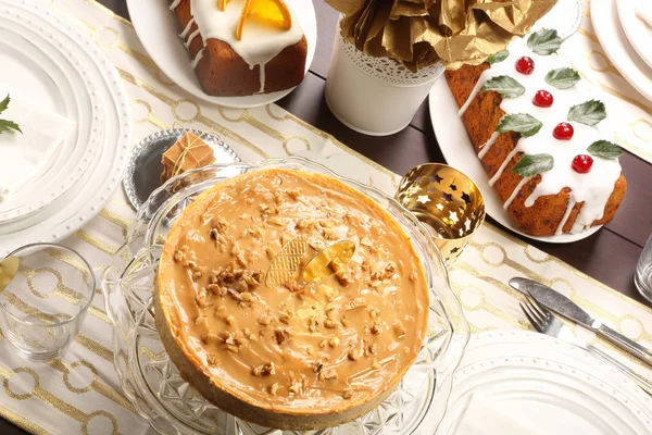 Caramelo de bolo de queijo de Natal com nozes na mesa decorada — Fotografia de Stock