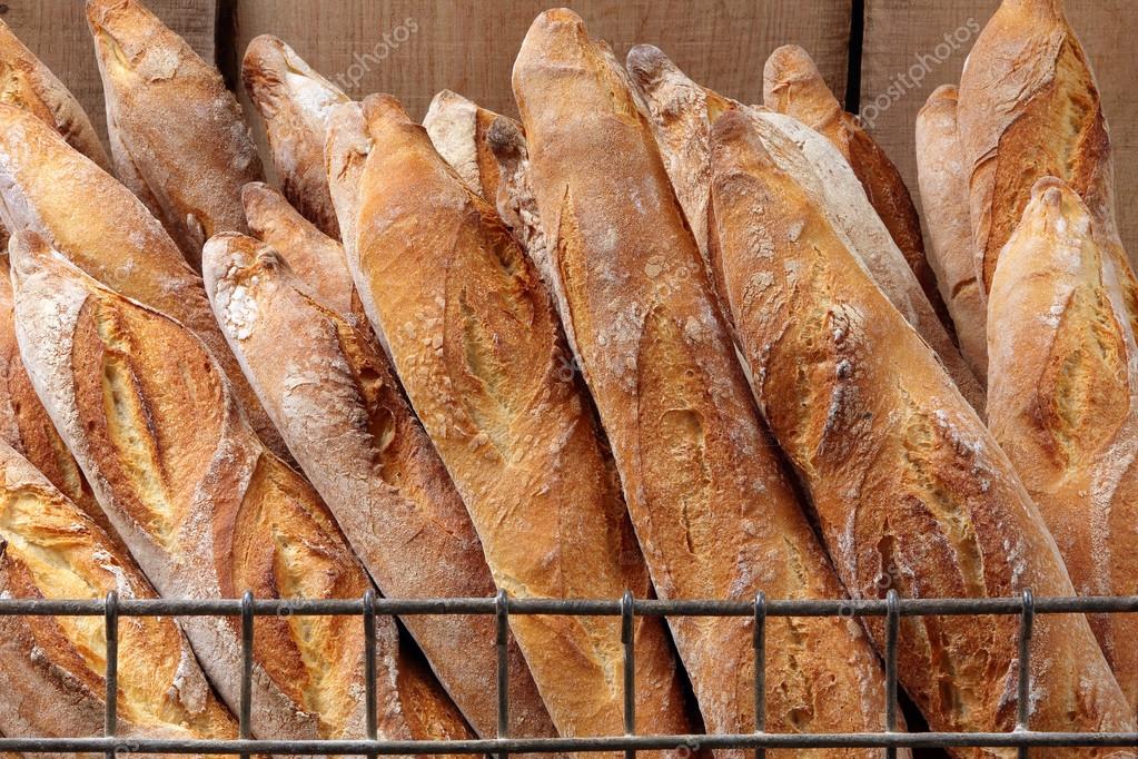 French baguettes in metal basket in bakery — Stock Photo ©
