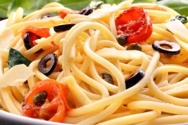 Spaghetti with olive sauce and tomatoes clipart