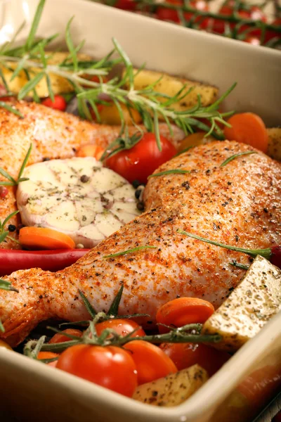 Chicken legs with vegetables and herbs ready for roasting Stock Picture