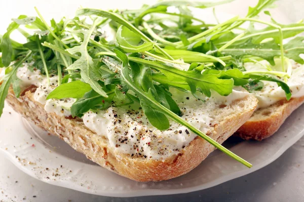 Fit healthy sandwich with white cheese and arugula