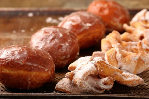 Donuts and faworki. Traditional Polish cookies on Fat Thursday — Stock Photo, Image