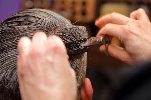 Barber cutting and modeling hair by scissors and comb — Stock Photo, Image