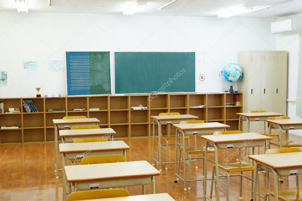School classroom with school desks and blackboard
