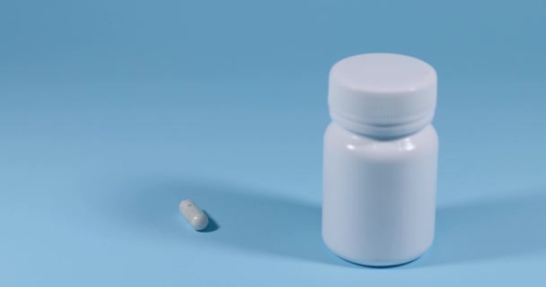 Super Slow Motion Spinning Medical Pill Pill Bottle Blue Background — Stock Video