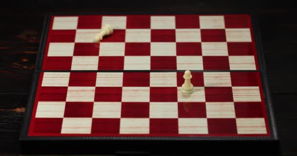 Black chess piece falling over, Stock Video