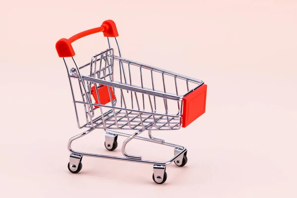 Shopping Cart Beige Background Shop Trolley Supermarket Sale Discount Shopaholism — Stock Photo, Image