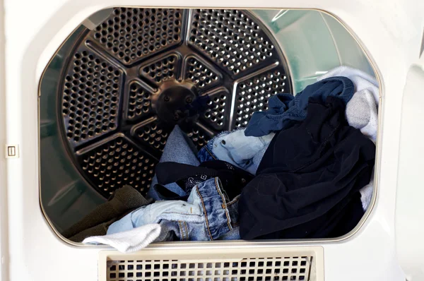 Open dryer with laundry — Stock Photo, Image