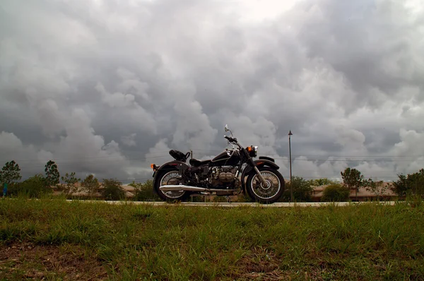 Vintage motorcycle on empty highway — Stock Photo, Image