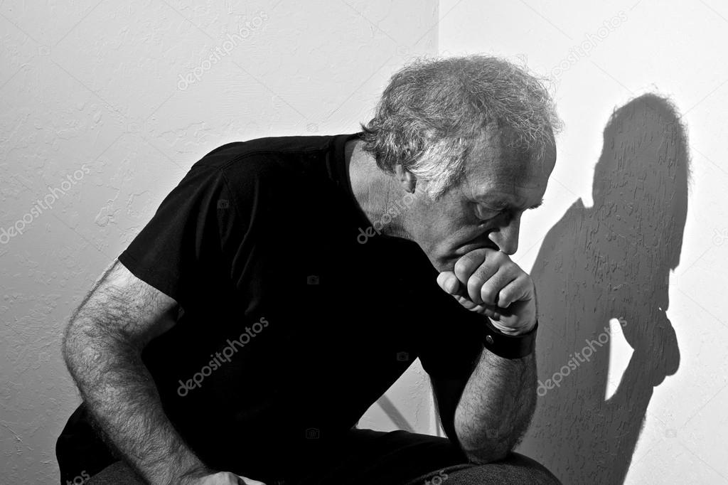 white older man sitting and thinking