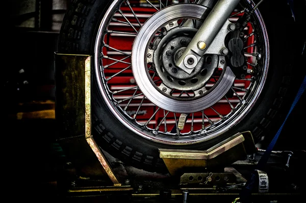 Motorcycle wheel in holder — Stock Photo, Image