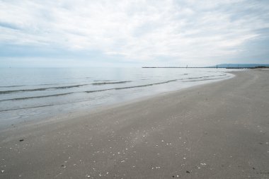 Boş bir bulutlu gün kumsalda.