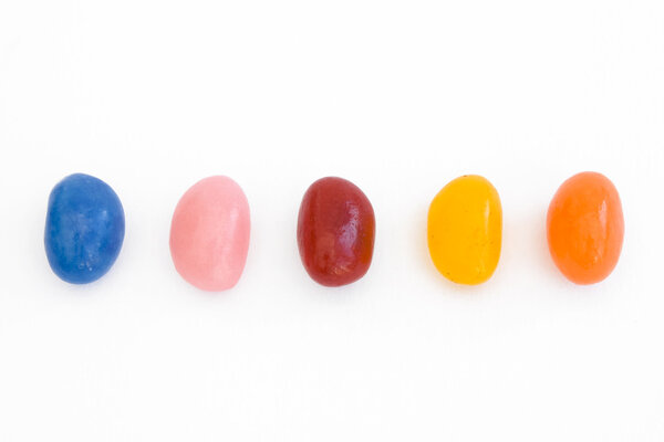 A line of jelly beans over white