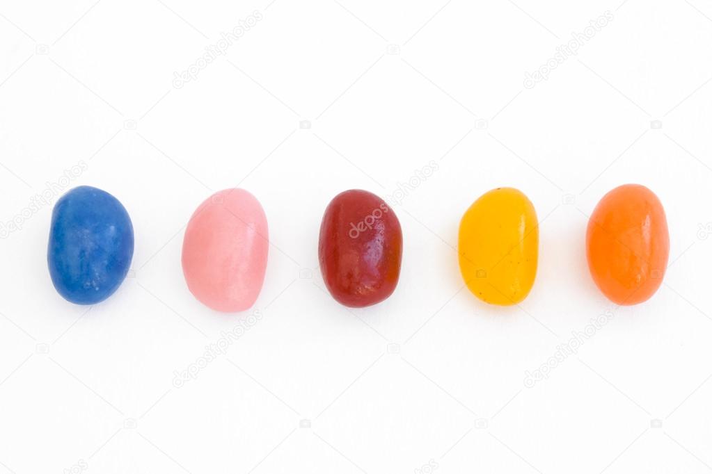 A line of jelly beans over white