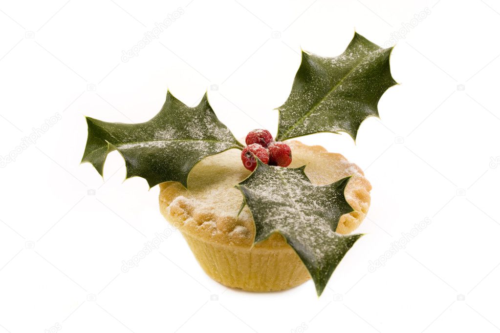 Single mince pie decorated with holly over white.