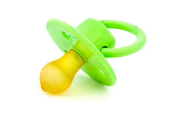 Green baby's dummy over white — Stock Photo, Image