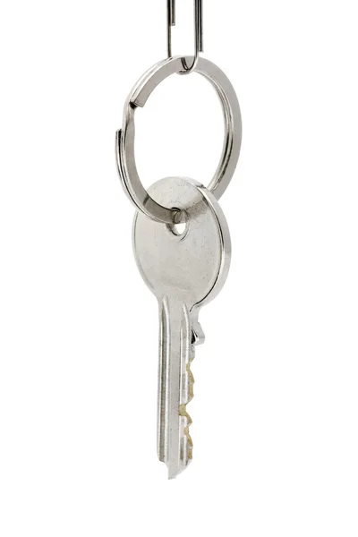 Single key hanging on a key ring over white — Stock Photo, Image