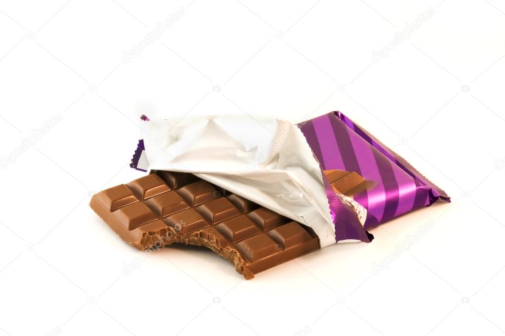 Chocolate bar with a missing bite in the wrapper over white