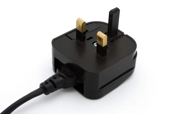 Preto UK plug sobre branco — Fotografia de Stock