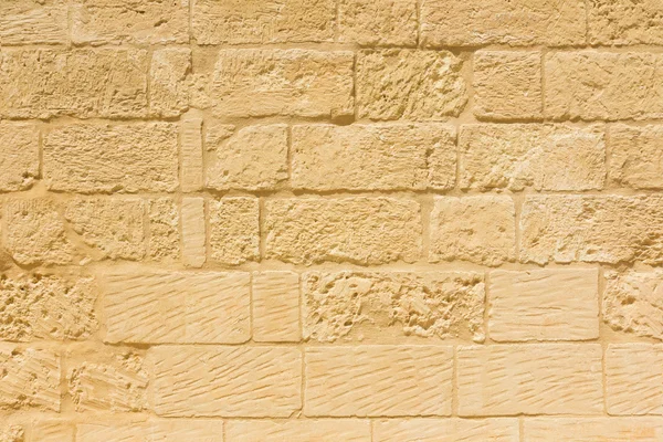 Weathered sandstone brick wall — Stock Photo, Image