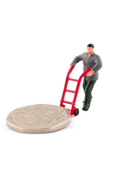 Minature figure moving a coin over white — Stock Photo, Image