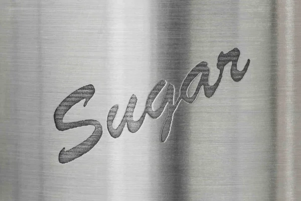 Das Wort Zucker auf einem metallenen Baackground — Stockfoto