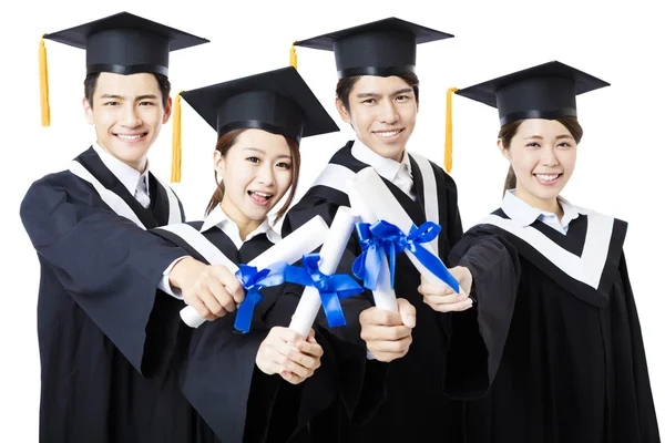 Hochschulabsolventen im Abschlusskleid stehend und lächelnd — Stockfoto