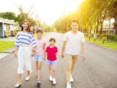 Mutlu Asyalı bir aile sokakta yürüyor.