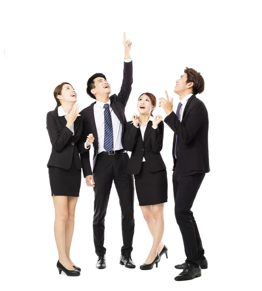 Happy business group pointing and looking up — Stock Photo, Image