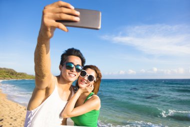 tatil selfie fotoğraf vasıl belgili tanımlık kıyı yo alarak genç Çift