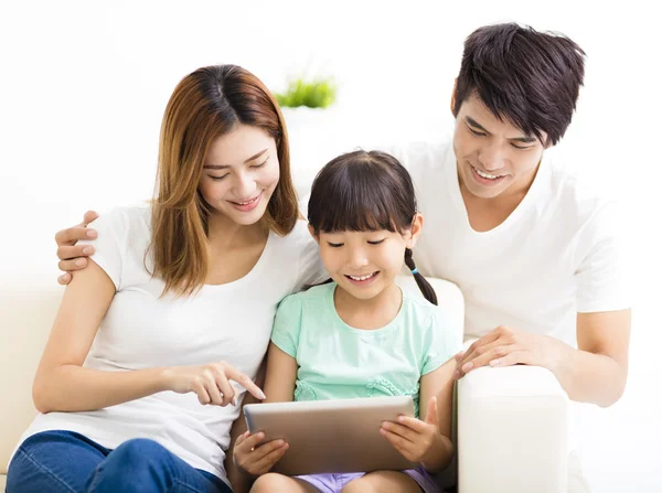 Happy family and daughter  using tablet on sofa — Stock Photo, Image