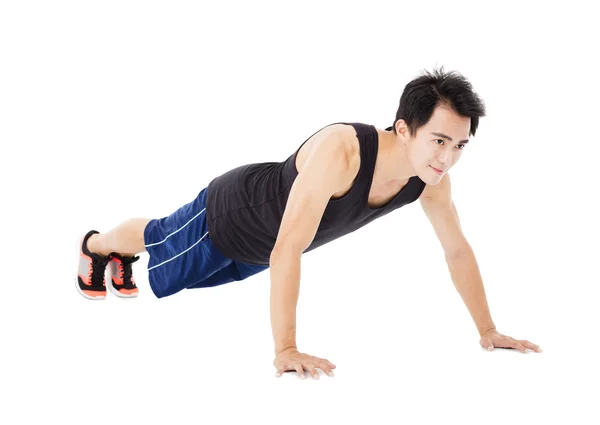 Joven guapo hombre haciendo push up ejercicio — Foto de Stock