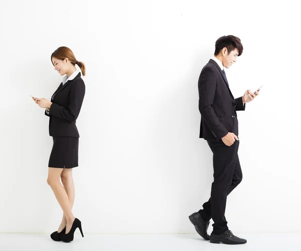 Unga företag man och kvinna med smart telefon — Stockfoto