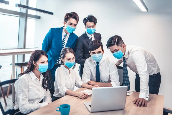 Busines people wearing face mask and  Business meeting in modern office while pandemic of virus