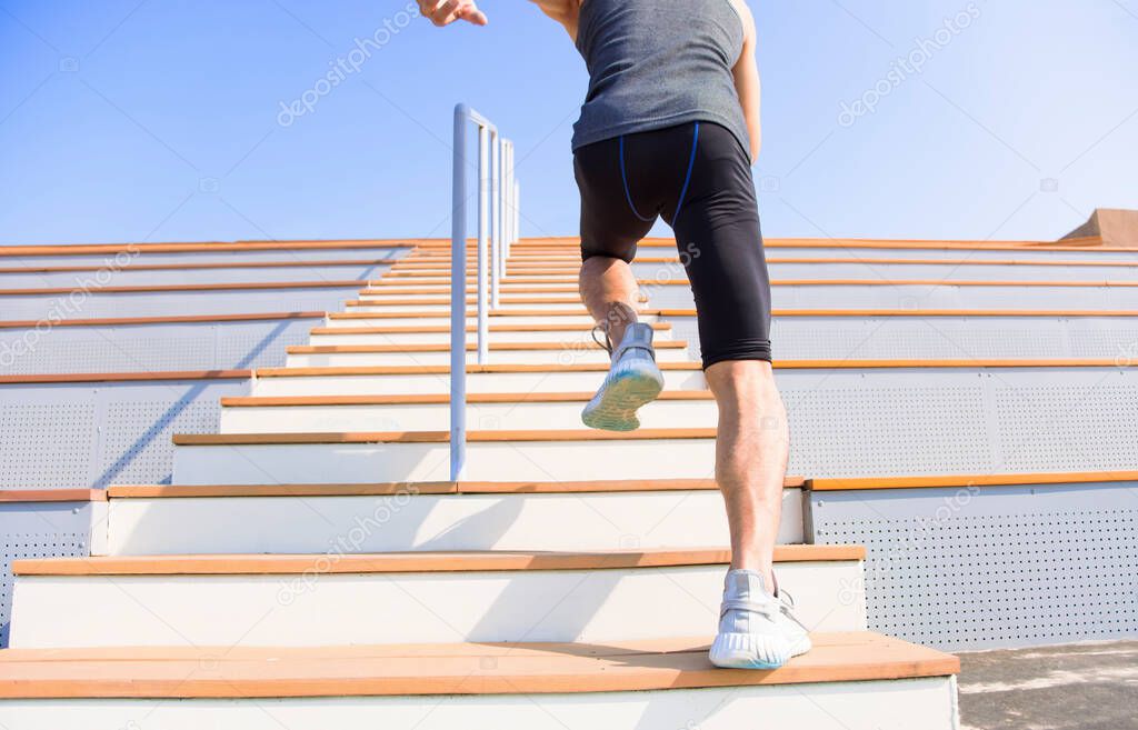 young man running upstairs at  stadium