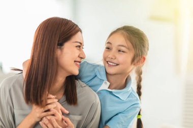 Mutlu anne ve küçük kız evde eğleniyorlar.