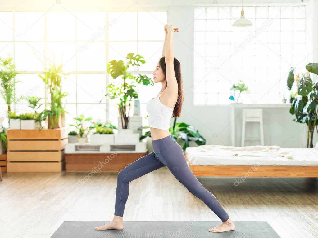 young woman, wearing casual sports clothing, exercises at home every day, stretch exercises, yoga, fitness