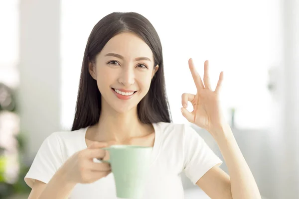 美丽的年轻女子举着一杯茶 摆出一副不错的姿势 — 图库照片