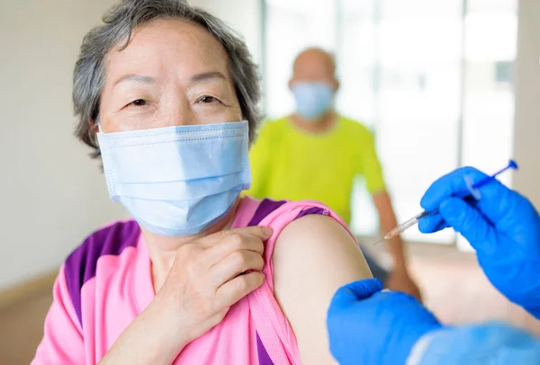 Läkare Som Injicerar Vaccin Till Äldre Kvinnor — Stockfoto