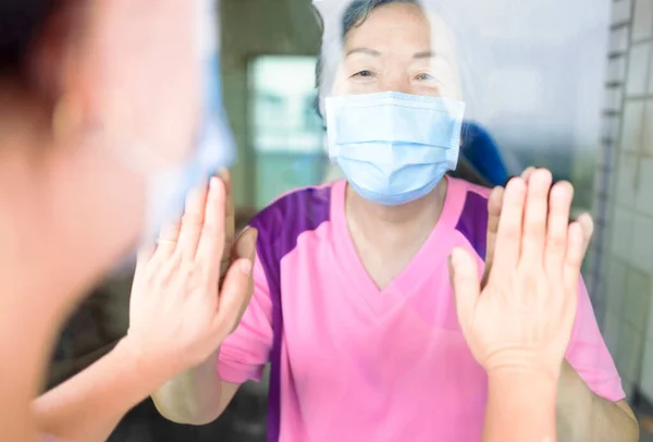 Eine Seniorin Medizinischer Maske Kommuniziert Durch Das Fenster Mit Ihrer — Stockfoto