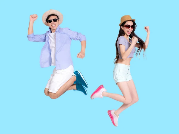 Happy Young Couple Sunglasses Jumping Isolated Blue Background — Stock Photo, Image