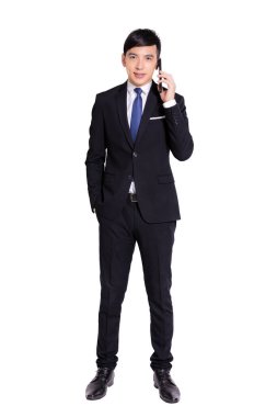 Young businessman talking on the mobile phone.Full length portrait.Isolated on white background.