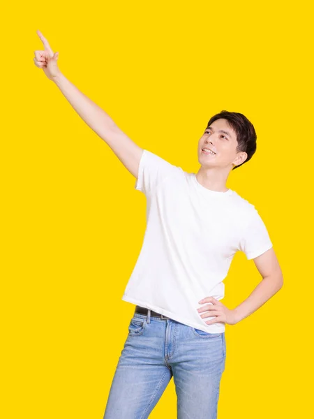 Happy Handsome Smiling Young Man Hands Poiting Isolated Yellow Background — Stock Photo, Image