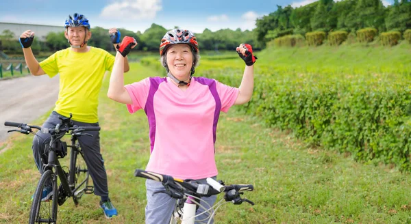 Happy Asian Healthy Senior Couple Exercising Bicycles — Stock Photo, Image