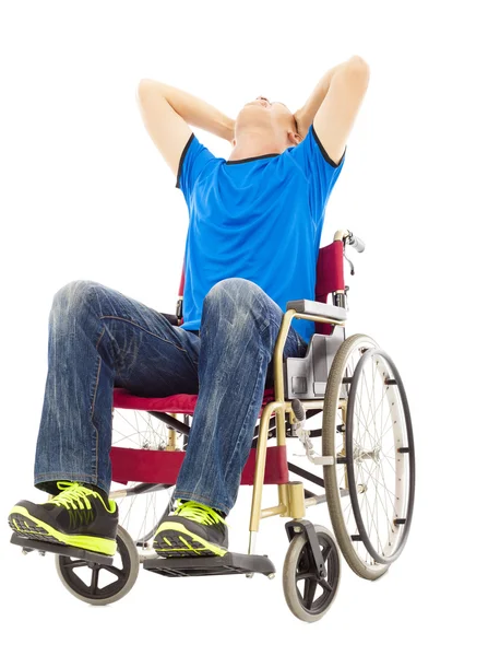 Сидящий на инвалидной коляске в состоянии депрессии и в наручниках мужчина — стоковое фото